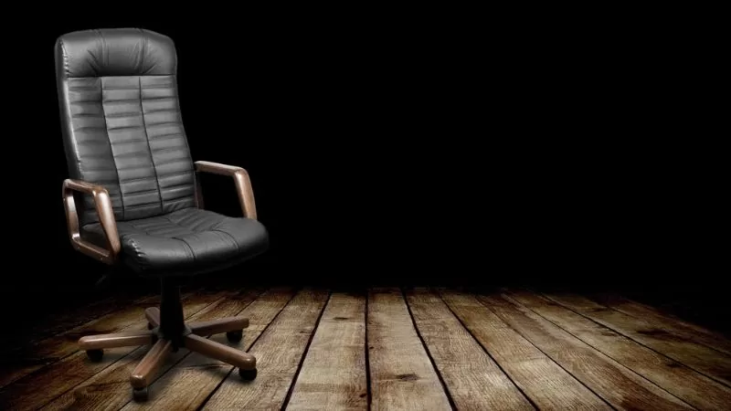 black executive chair in dark room